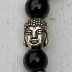 a bead with a buddha on it