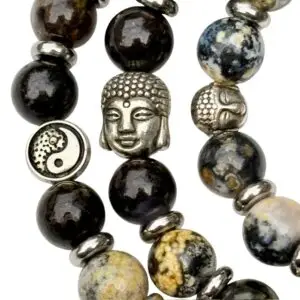 a close up of a bracelet with yin yang or buddha