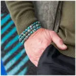 Hand wearing turquoise beaded bracelet