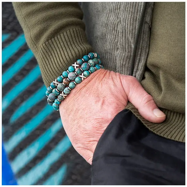 Hand wearing turquoise beaded bracelet